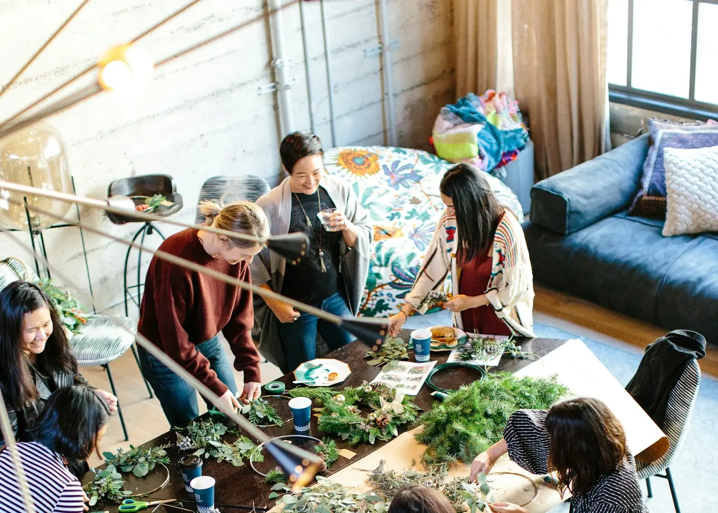 Menschen arbeiten gemeinsam an einem großen Tisch mit Pflanzen
